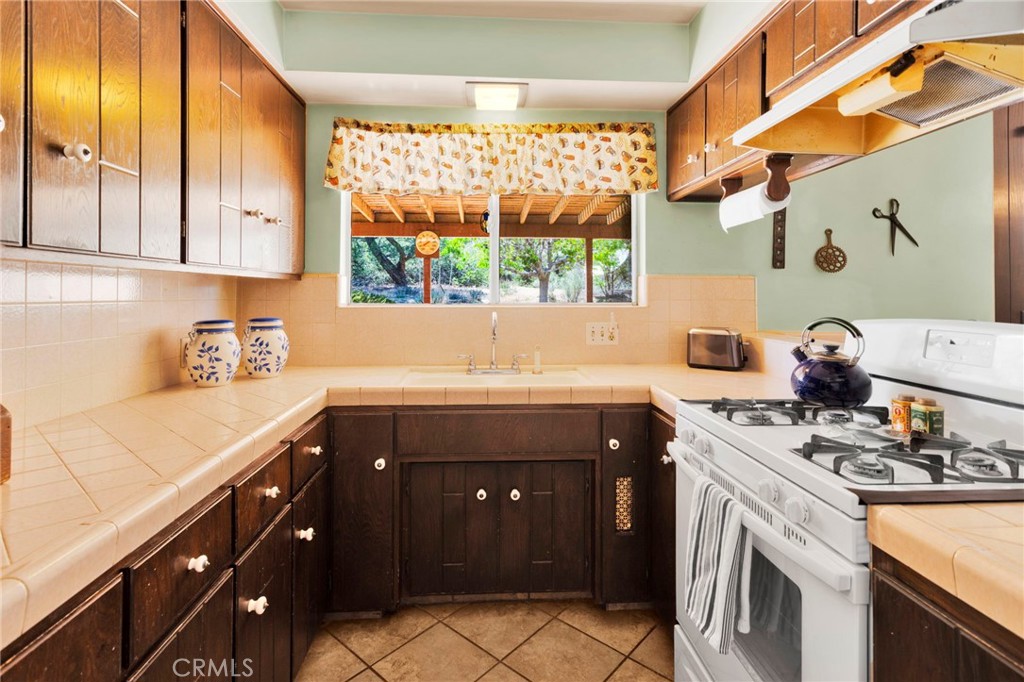 5500 Oil Well Road Phelan, CA 92371 - Photo 7 of 65 a kitchen with a sink stove and cabinets
