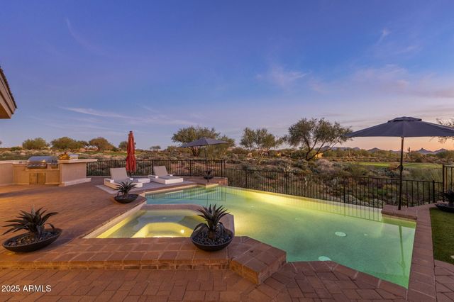 a large kitchen with stainless steel appliances granite countertop a lot of counter space and wooden floor