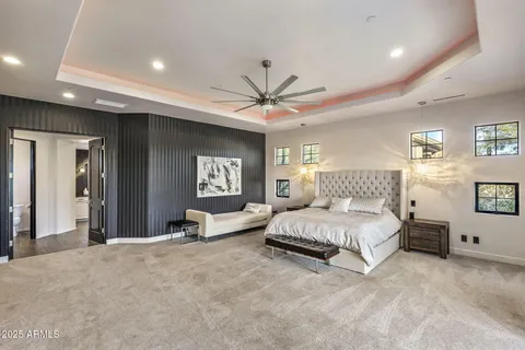 a bedroom with a large bed and a large window