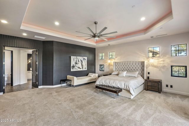 a bedroom with a large bed and a large window