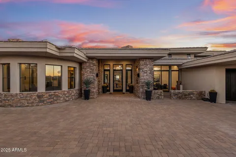 a view of roof deck with couches and city view