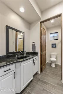 an aerial view of residential houses with outdoor space and trees