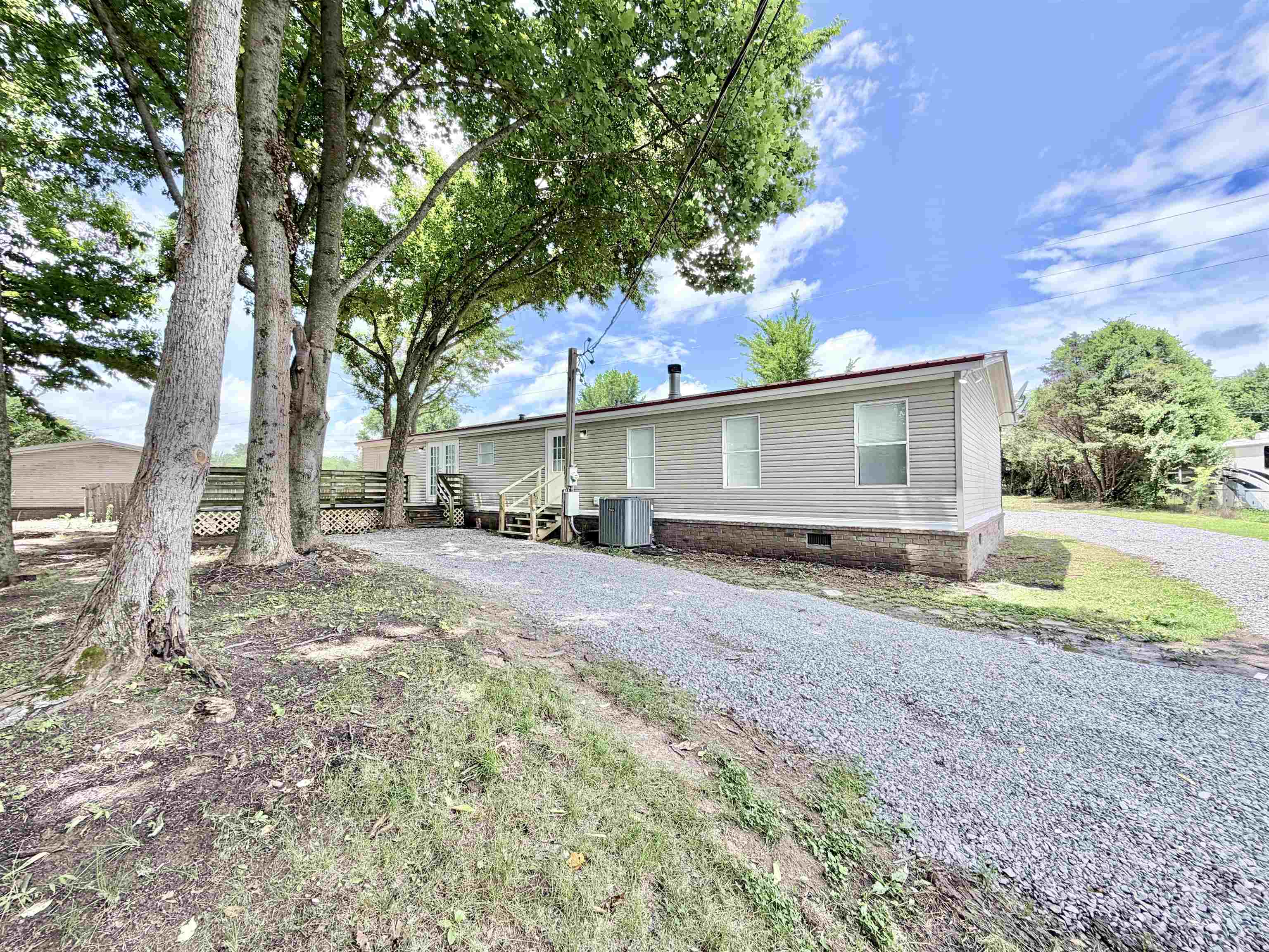 1655 Fayne Road Brighton, TN 38011 - Photo 27 of 28 Siding exterior with multiple windows and a red-toned roof