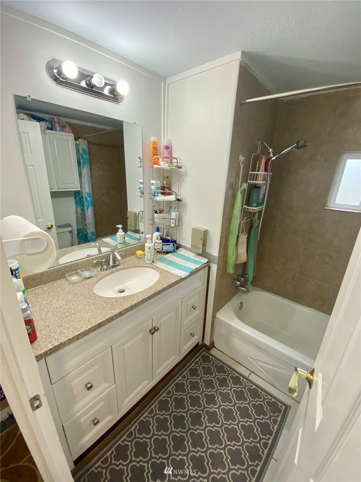 15232 Southeast 272nd Street, Unit 99 Kent, WA 98042 - Photo 8 of 15 a bathroom with a double vanity sink a mirror and a bathtub