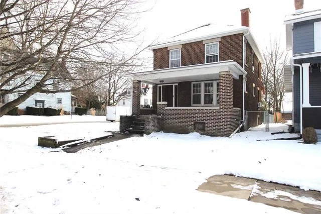 a view of a house with snow on the road