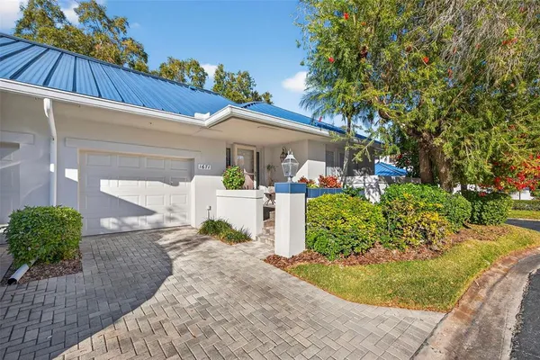 a front view of a house with a yard garage and outdoor seating
