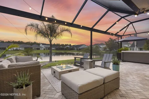 a view of a lake with a floor to ceiling window next to a yard