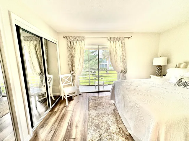 a bedroom with a bed and a large window