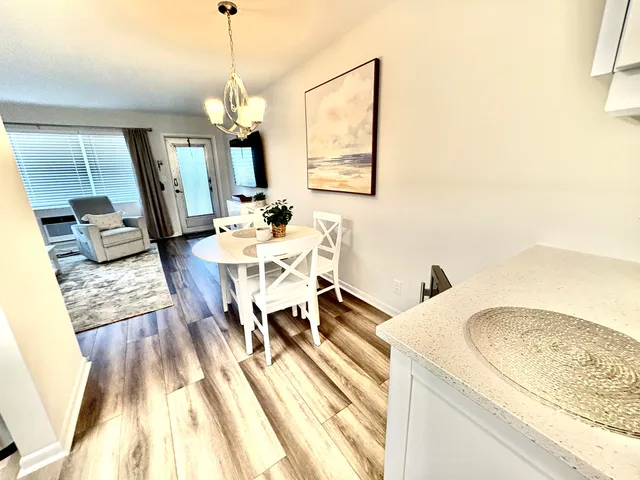 a view of a dining room with furniture window and wooden floor