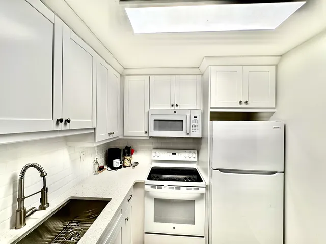 a kitchen with cabinets and appliances