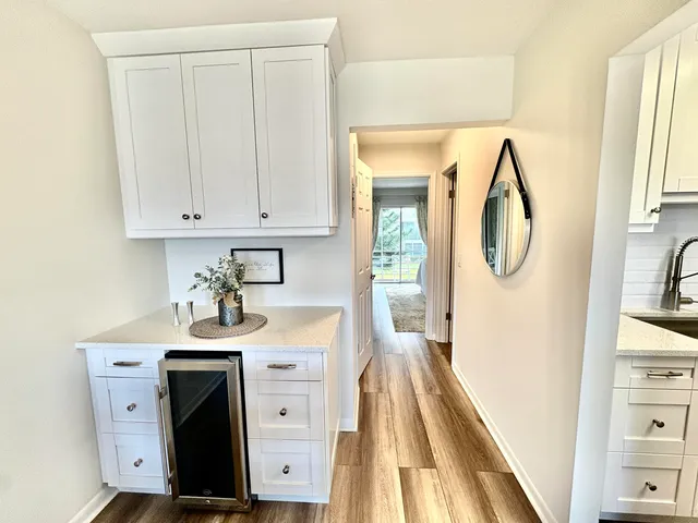 a room with wooden floor washer and dryer