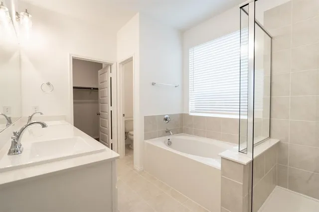 a bathroom with a bathtub and a sink