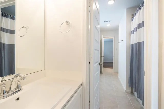 a bathroom with a sink a mirror and a shower