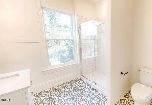 a bathroom with a window and a shower