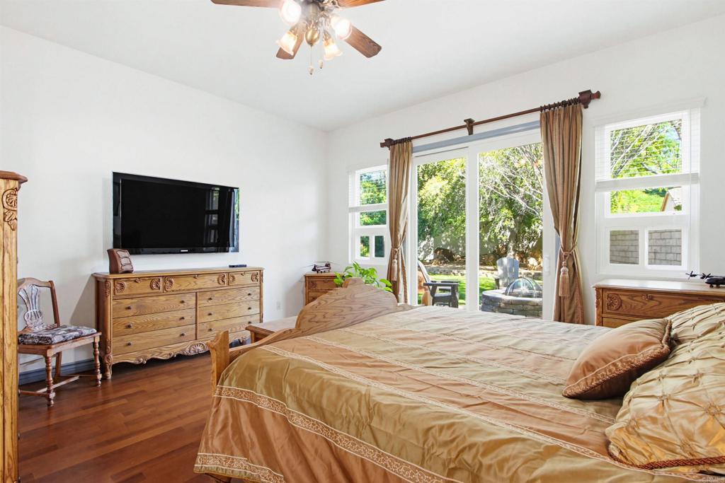 2194 Stone Castle Fallbrook, CA 92028 - Photo 28 of 60 a bedroom with a bed and flat tv screen on dresser