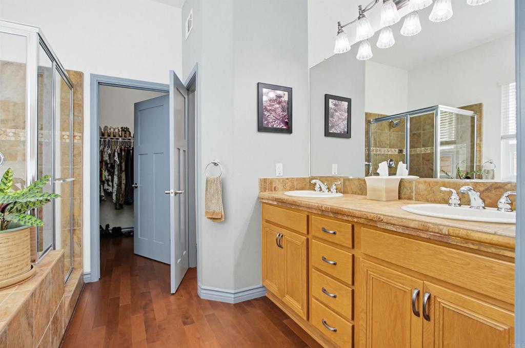 2194 Stone Castle Fallbrook, CA 92028 - Photo 30 of 60 a spacious bathroom with a granite countertop sink a mirror and a shower