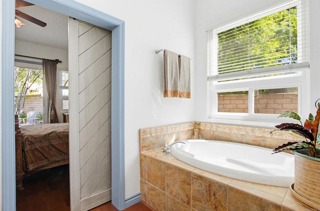 2194 Stone Castle Fallbrook, CA 92028 - Photo 32 of 60 a bathroom with a tub a sink and a window