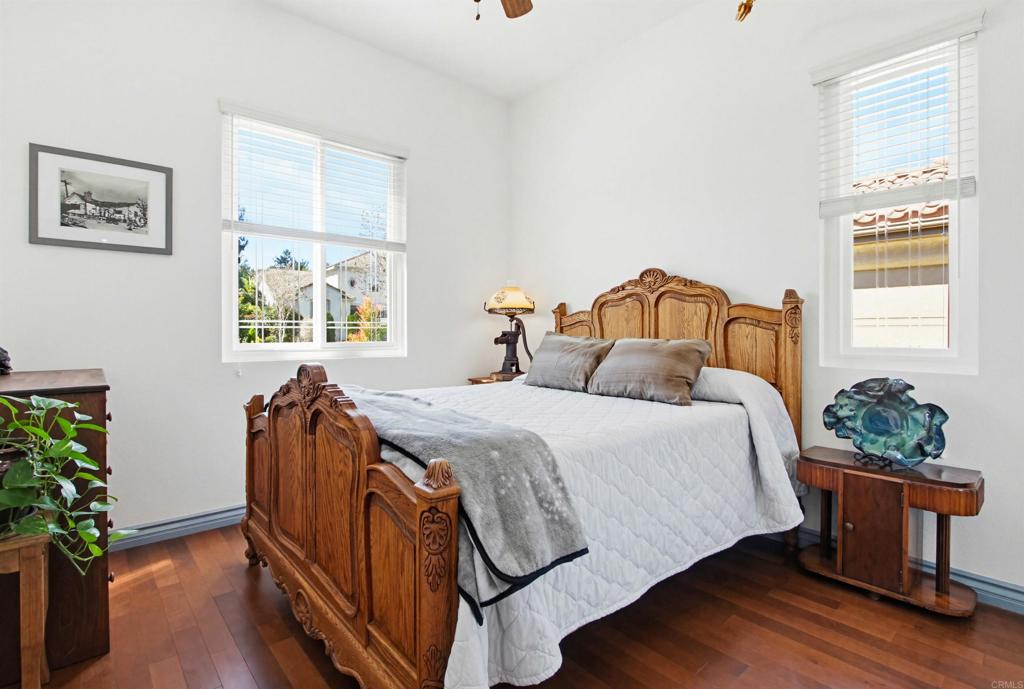 2194 Stone Castle Fallbrook, CA 92028 - Photo 36 of 60 a bedroom with a bed and wooden floor