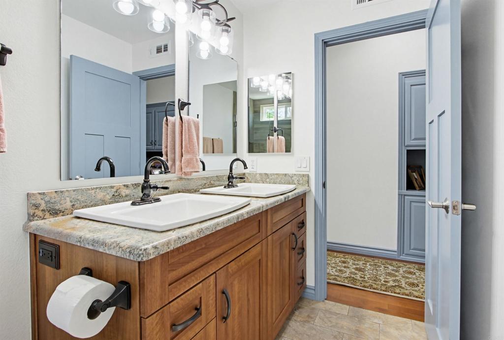 2194 Stone Castle Fallbrook, CA 92028 - Photo 39 of 60 a bathroom with a sink and a mirror