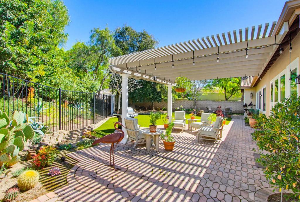 2194 Stone Castle Fallbrook, CA 92028 - Photo 47 of 60 a view of a patio with a table chairs and a large tree