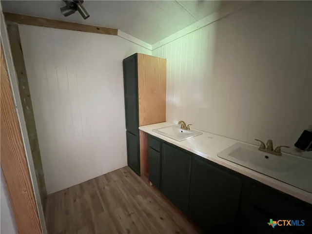 a bathroom with a sink and mirror