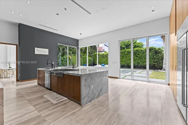 a kitchen with kitchen island and a large window