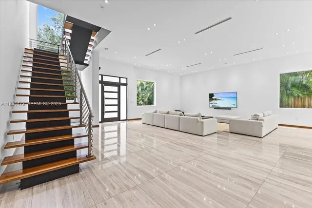 a view of a living room with furniture and wooden floor