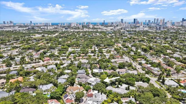 a view of a park with slide and a tree