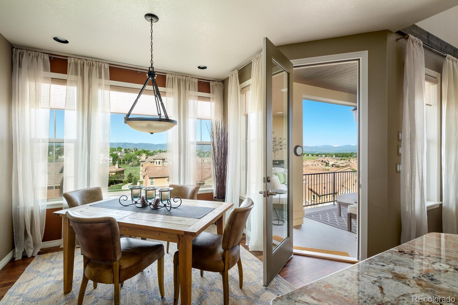 9367 Viaggio Way Highlands Ranch, CO 80126 - Photo 5 of 9 a view of a dining room with furniture window and outside view