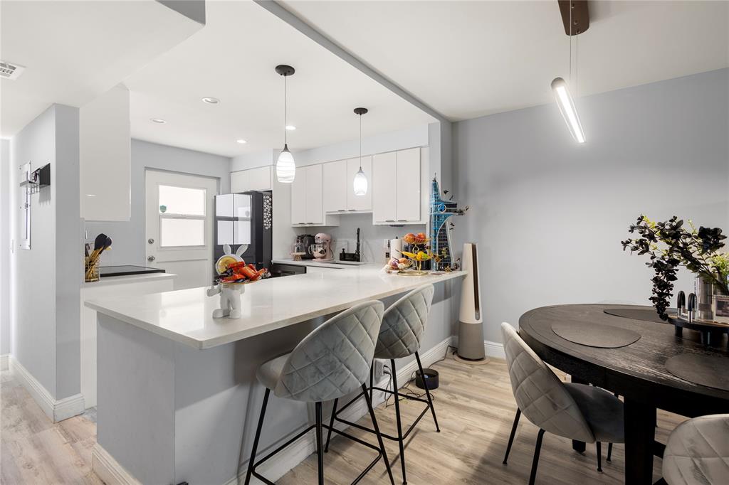 a kitchen with appliances a sink and a dining table