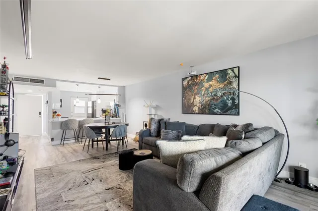 a living room with furniture and a painting on the wall