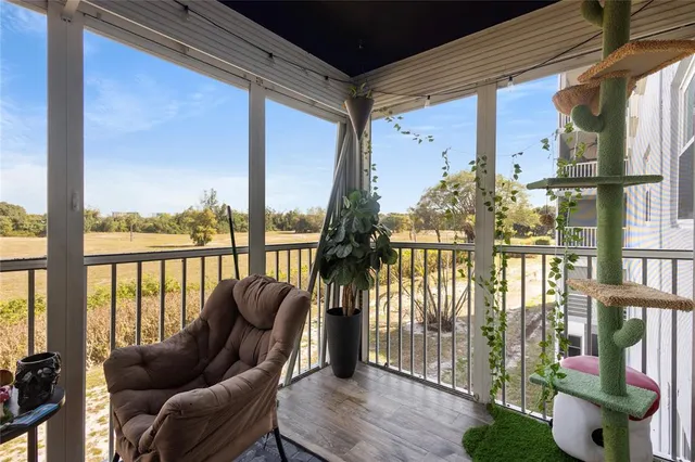 a living room with furniture and a floor to ceiling window