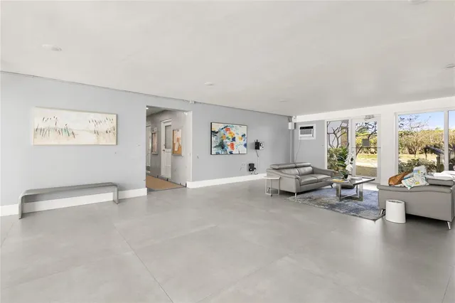 a living room with furniture and painting on the wall