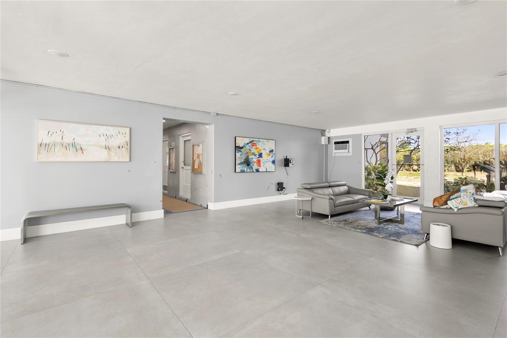 5500 Northwest 2nd Avenue, Unit 316 Boca Raton, FL 33487 - Photo 28 of 31 a living room with furniture and a large window