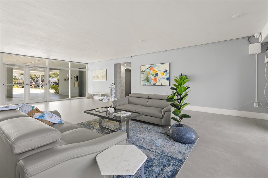 5500 Northwest 2nd Avenue, Unit 316 Boca Raton, FL 33487 - Photo 29 of 31 a living room with furniture and painting on the wall