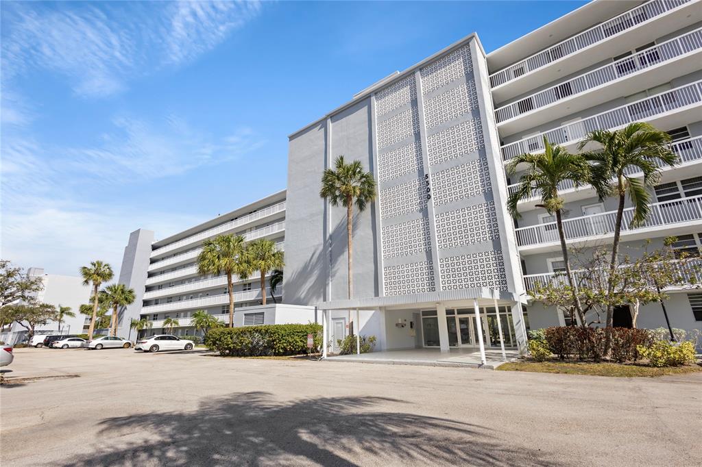 5500 Northwest 2nd Avenue, Unit 316 Boca Raton, FL 33487 - Photo 3 of 31 a front view of a building with a road and plants