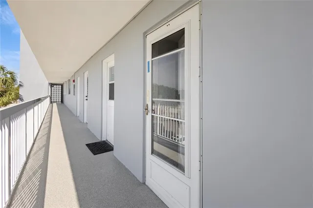 a view of a hallway with wooden floor and entryway