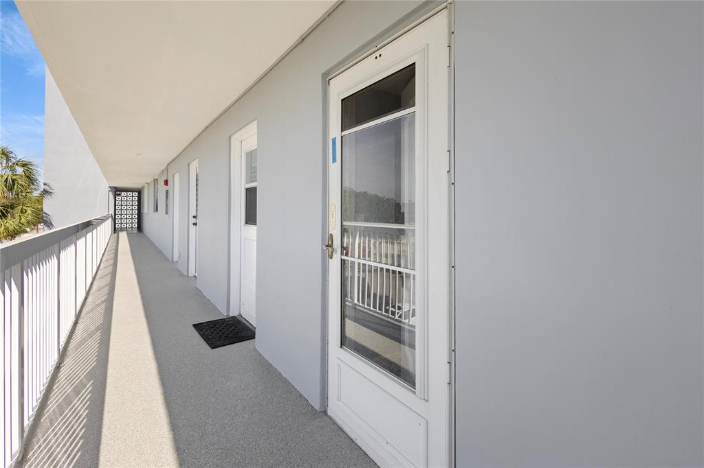5500 Northwest 2nd Avenue, Unit 316 Boca Raton, FL 33487 - Photo 5 of 31 a view of a hallway with wooden floor and entryway