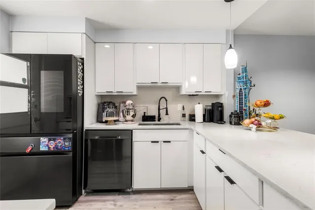 a kitchen with stainless steel appliances a sink stove and cabinets