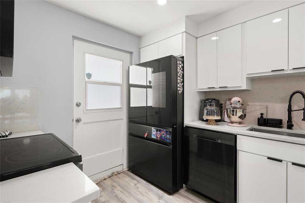 5500 Northwest 2nd Avenue, Unit 316 Boca Raton, FL 33487 - Photo 9 of 31 a kitchen with stainless steel appliances granite countertop a refrigerator and a sink