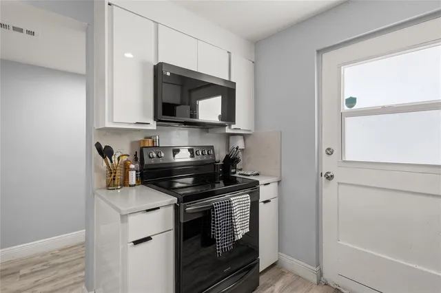 a living room with furniture or couch and a potted plant