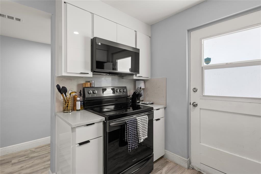 5500 Northwest 2nd Avenue, Unit 316 Boca Raton, FL 33487 - Photo 10 of 31 a kitchen with a stove and a microwave