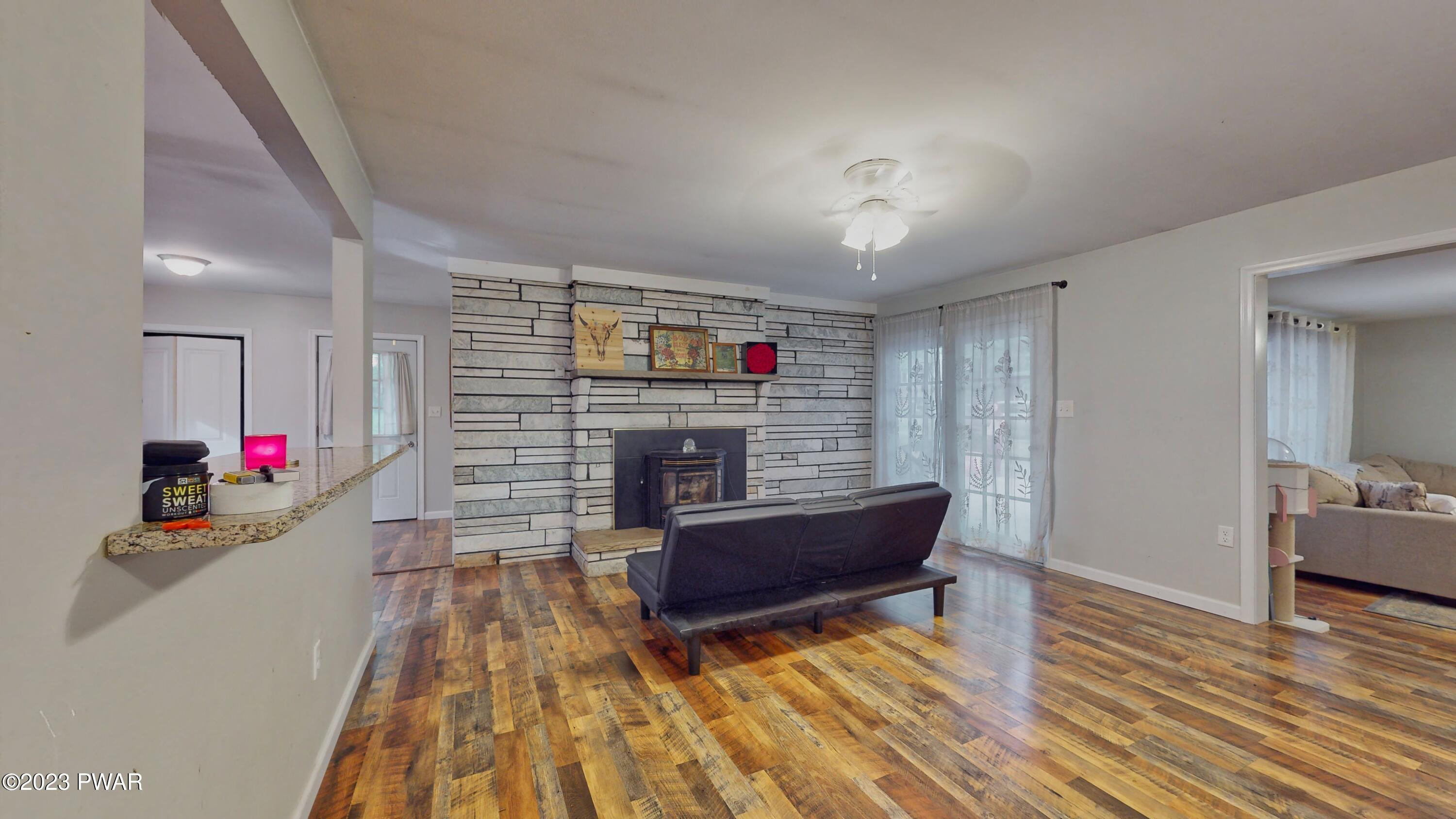 149 Walker Lake Road Shohola, PA 18458 - Photo 36 of 51 a living room with furniture and a wooden floor