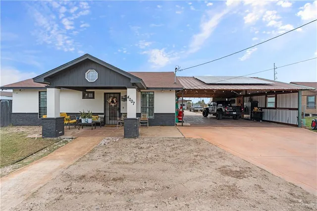 a front view of a house with yard and porch