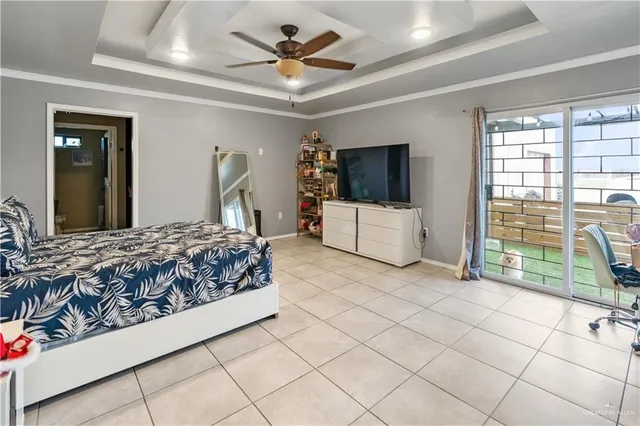 a bedroom with a large bed and a flat tv screen