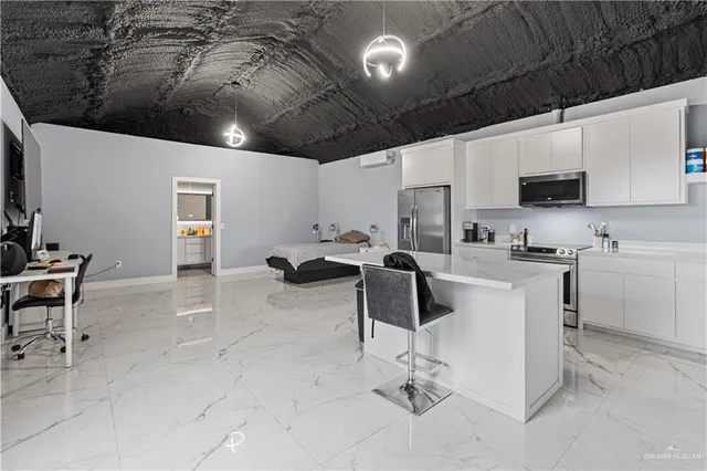a kitchen with a sink a counter top space appliances and cabinets