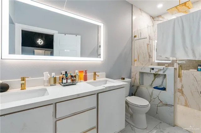a bathroom with a toilet sink and mirror