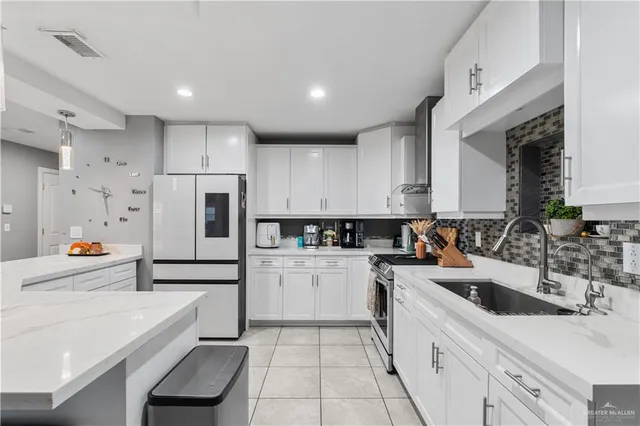 a kitchen with white cabinets and white appliances