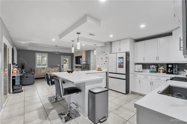a kitchen with refrigerator and cabinets