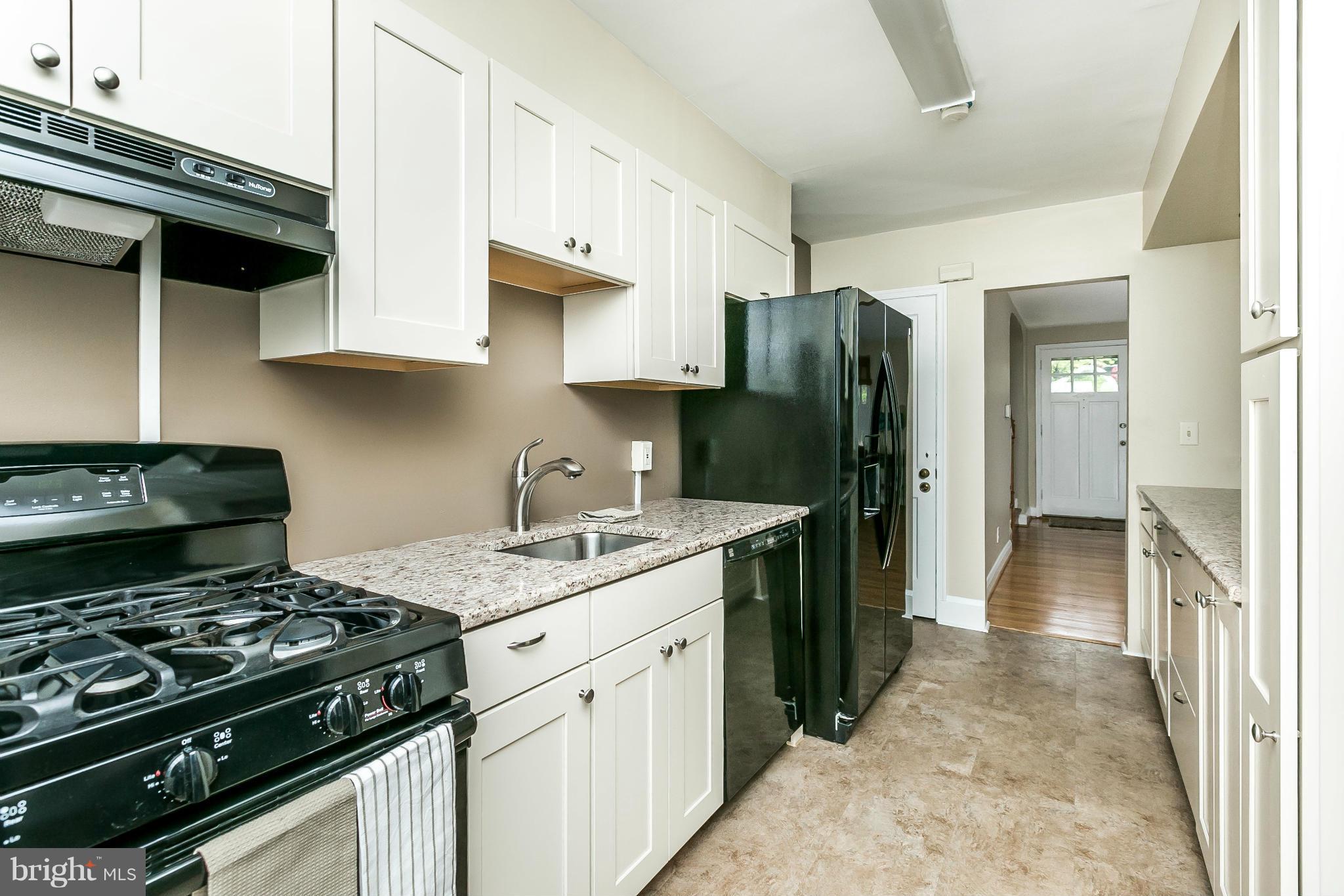 120 Stanmore Road Baltimore, MD 21212 - Photo 12 of 27 a kitchen with a stove and a refrigerator
